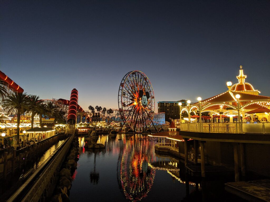 Pixar Pier lit up at night across the lagoon at Disney California Adventure